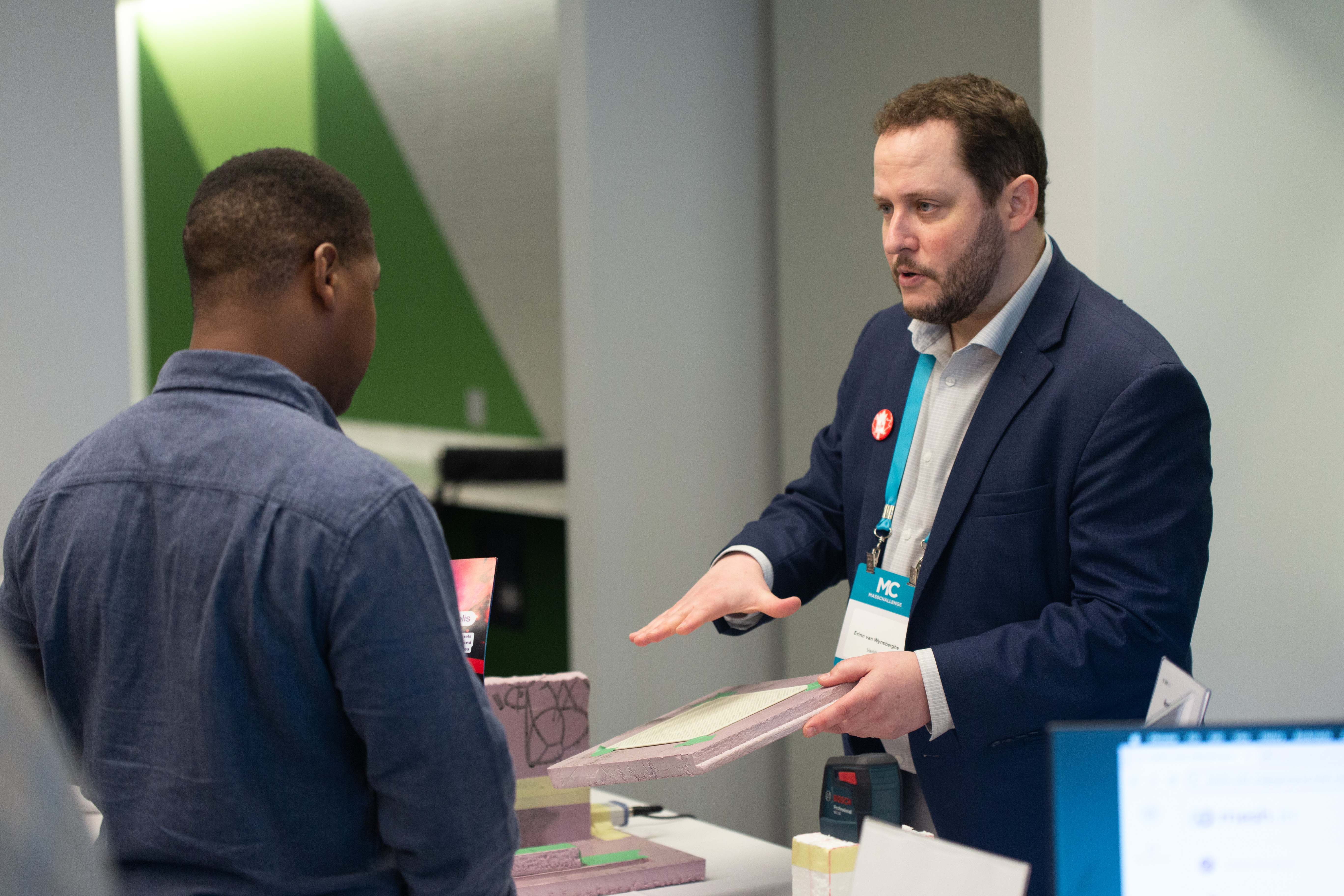 Erinn van Wynsberghe, CEO of VanWyn shares his technology with an attendee.